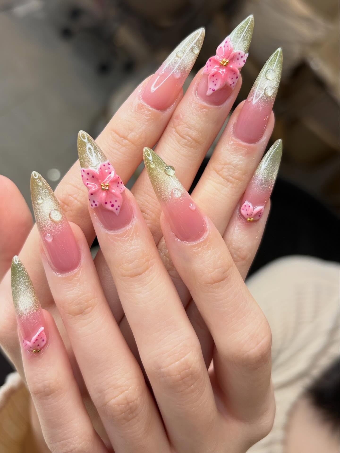 Soft blush manicure with metallic butterfly details